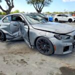 BMW M2 coupe with severe driver side and front-end collision damage at Jacksonville assessed for total loss appraisal