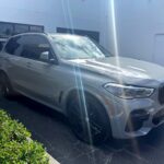 BMW X5 M50i luxury SUV with black wheels photographed in Jacksonville for total loss appraisal