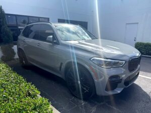 BMW X5 M50i luxury SUV with black wheels photographed in Jacksonville for total loss appraisal