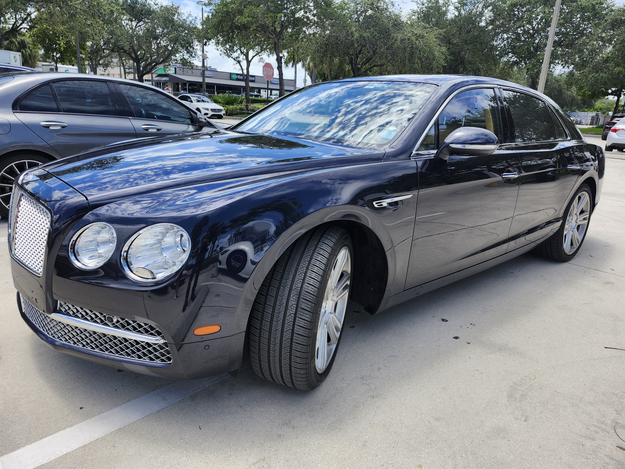 Bentley Flying Spur luxury sedan photographed in Miami parking lot for total loss appraisal
