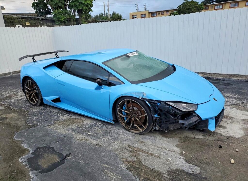 Lamborghini Huracan supercar with front-end collision damage and cracked windshield assessed for total loss appraisal in Miami