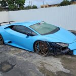 Lamborghini Huracan supercar with front-end collision damage and cracked windshield assessed for total loss appraisal in Miami