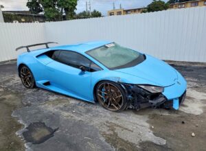 Lamborghini Huracan supercar with front-end collision damage and cracked windshield assessed for total loss appraisal in Miami