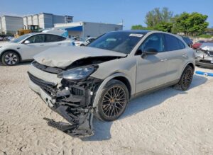 2021 Porsche Cayenne Coupe with severe front-end collision damage and detached bumper in Orlando assessed for total loss appraisal