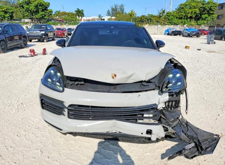 Porsche Cayenne SUV with severe front-end collision damage and detached bumper for total loss appraisal in Orlando