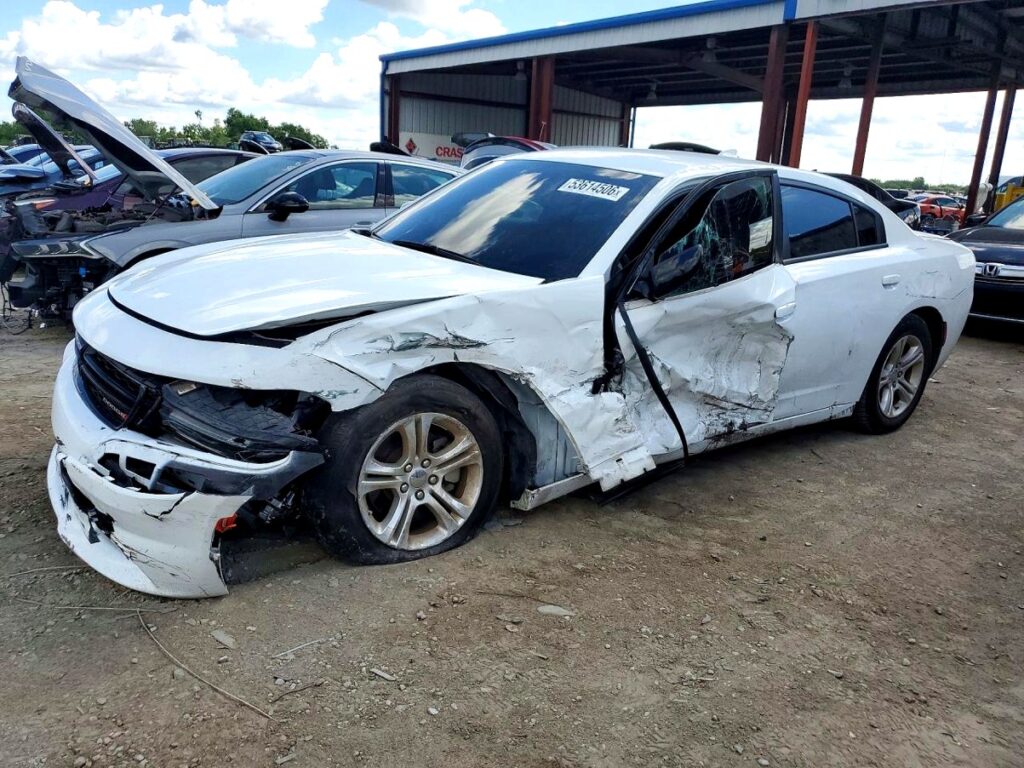 Dodge Charger sedan with severe front and side collision damage at Sarasota assessed for total loss appraisal