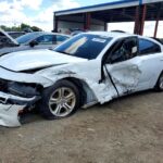 Dodge Charger sedan with severe front and side collision damage at Sarasota assessed for total loss appraisal