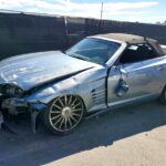 Silver Chrysler Crossfire convertible with severe front-end and driver side collision damage in Tallahassee assessed for total loss appraisal
