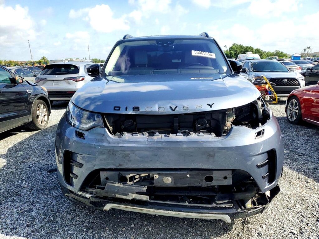 Land Rover Discovery SUV with severe front-end collision damage exposing engine bay at Tampa for total loss appraisal