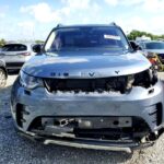 Land Rover Discovery SUV with severe front-end collision damage exposing engine bay at Tampa for total loss appraisal