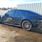 Porsche Panamera luxury sedan with driver side door and quarter panel collision damage assessed for total loss appraisal in Tampa