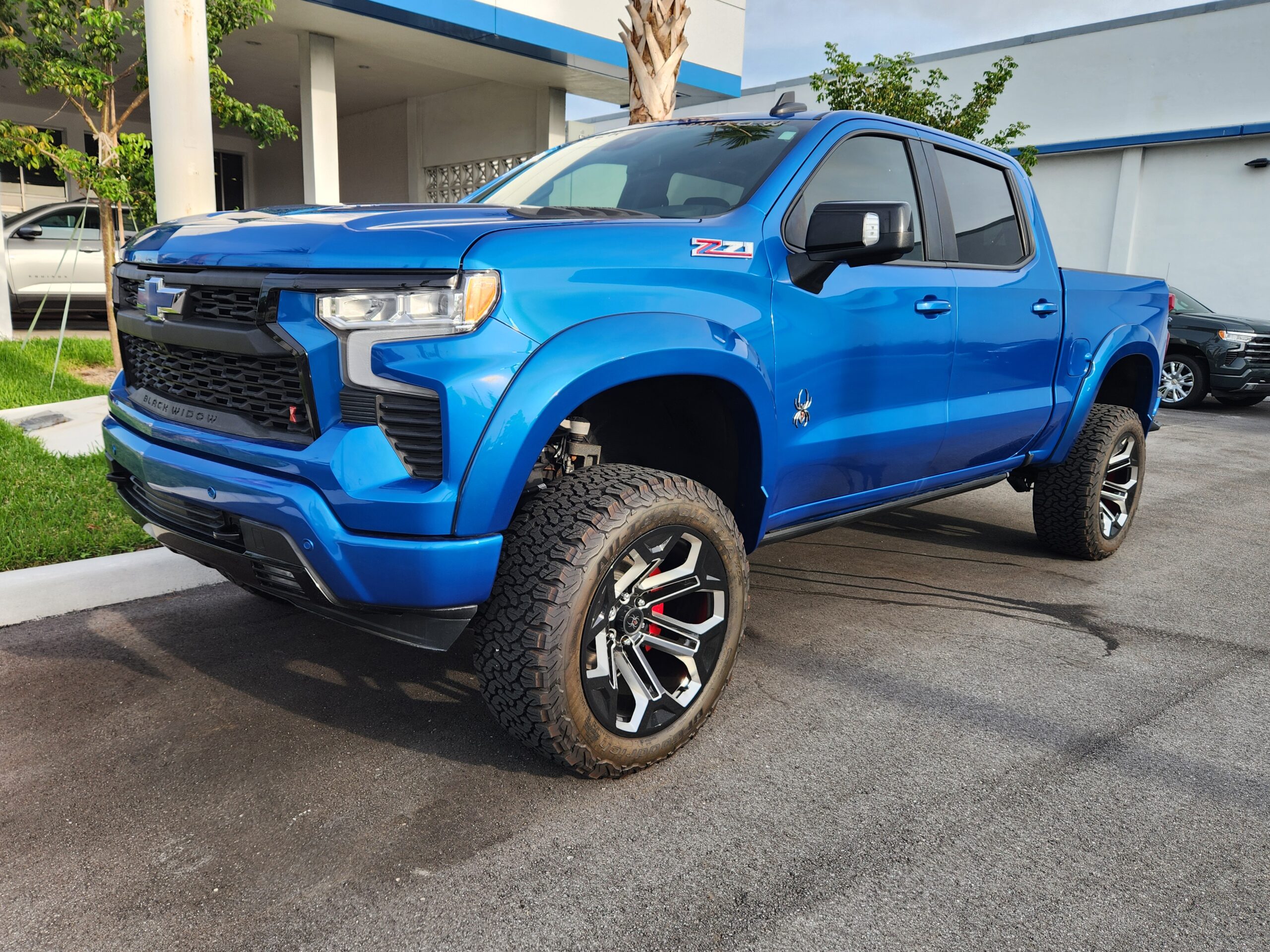 Chevrolet Silverado Z71 Black Widow lifted truck with custom off-road wheels and all-terrain tires photographed in West Palm Beach for total loss appraisal