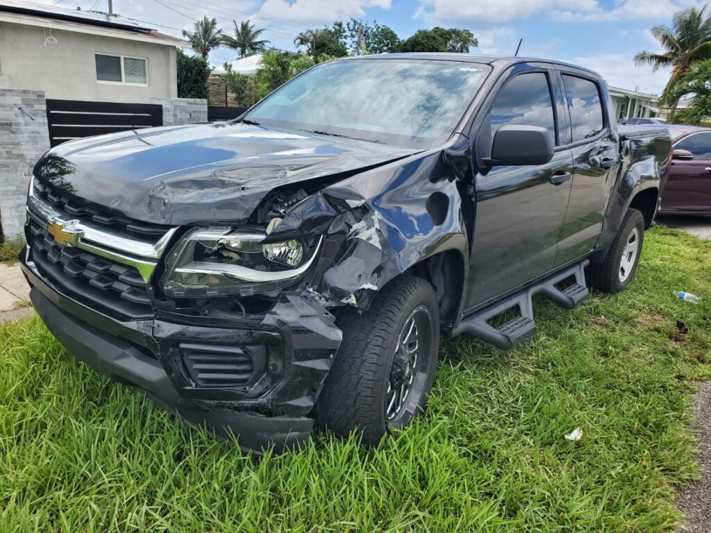 2022 Chevrolet Colorado midsize truck with front driver-side collision damage photographed for total loss claim in Boca Raton