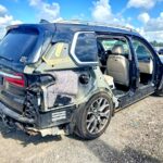 2020 BMW X7 with severe rear and passenger side collision damage exposing interior in Boca Raton for total loss appraisal