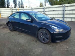 Black Tesla Model 3 sedan parked for inspection during total loss appraisal in Boca Raton, Florida