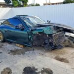 2012 Porsche 911 coupe with catastrophic front-end collision damage exposing engine components in Coral Gables for total loss appraisal