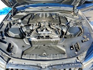 BMW M5 V8 engine bay inspected during total loss appraisal in Coral Gables, Florida