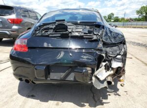 Black 2006 Porsche 911 with severe rear-end collision damage, evaluated for total loss appraisal in Fort Lauderdale, Florida