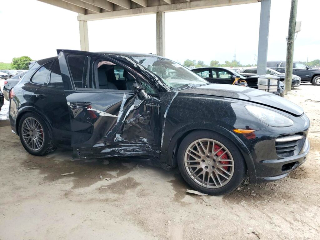 2013 Porsche Cayenne with severe driver side collision damage and shattered window in Jupiter assessed for total loss appraisal