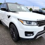 2016 Range Rover Sport with driver side door damage and black wheels photographed in Jupiter Florida for total loss appraisal