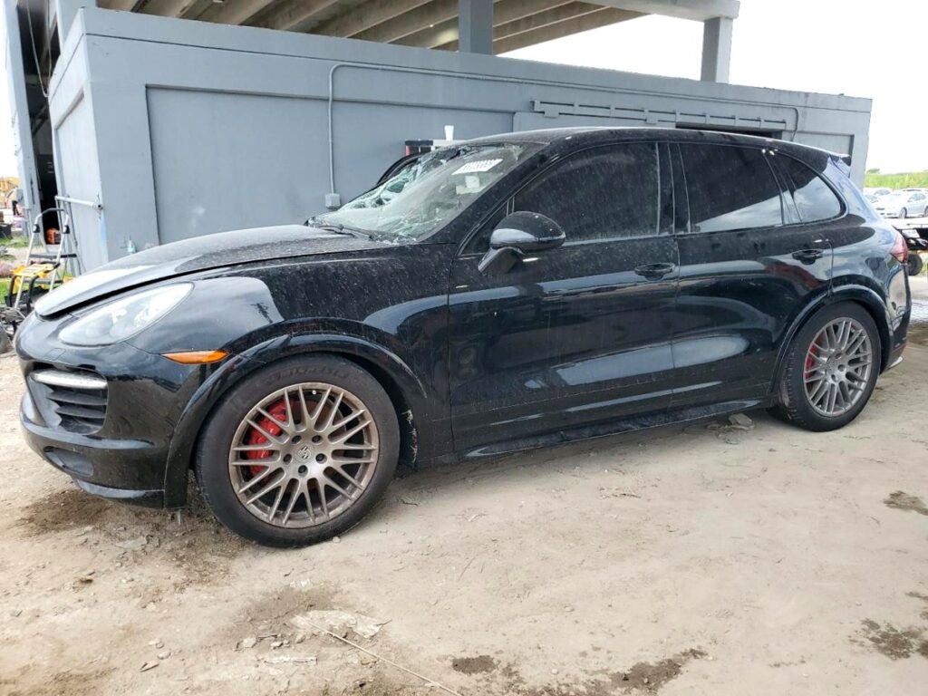 Black Porsche Cayenne with shattered windshield and front-end damage, assessed for total loss appraisal in Jupiter, Florida