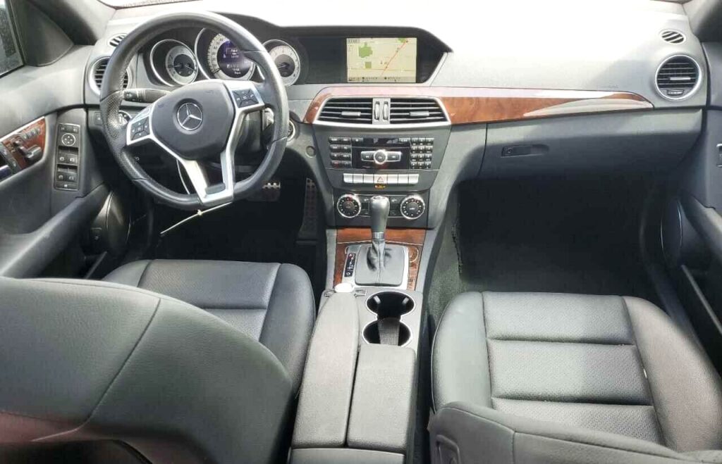 Interior dashboard and steering wheel of a 2014 Mercedes-Benz C250 inspected during total loss appraisal in Orlando, Florida