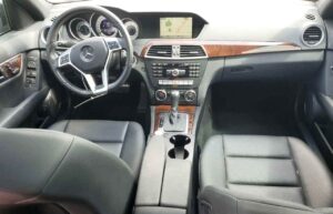 Interior dashboard and steering wheel of a 2014 Mercedes-Benz C250 inspected during total loss appraisal in Orlando, Florida