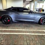 2018 Chevrolet Camaro SS with black wheels and red brake calipers side profile photographed in Pompano Beach for total loss appraisal