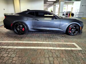 2018 Chevrolet Camaro SS with black wheels and red brake calipers side profile photographed in Pompano Beach for total loss appraisal