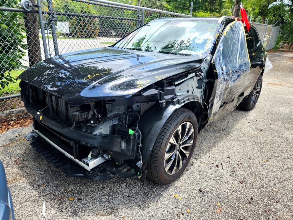 2025 Volvo XC90 with severe front-end and passenger side collision damage in Pompano Beach assessed for total loss appraisal