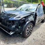 2025 Volvo XC90 with severe front-end and passenger side collision damage in Pompano Beach assessed for total loss appraisal