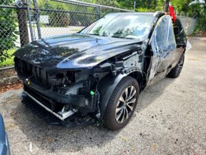 2025 Volvo XC90 with severe front-end and passenger side collision damage in Pompano Beach assessed for total loss appraisal