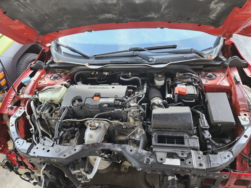 Open hood view of Honda Civic engine bay during total loss appraisal inspection in Royal Palm Beach, Florida