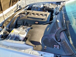Engine bay of a silver 2007 Jaguar XK inspected during total loss appraisal in Tallahassee, Florida
