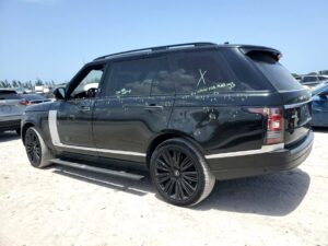 Black Range Rover with adjuster markings on the body during total loss appraisal in Wellington, Florida