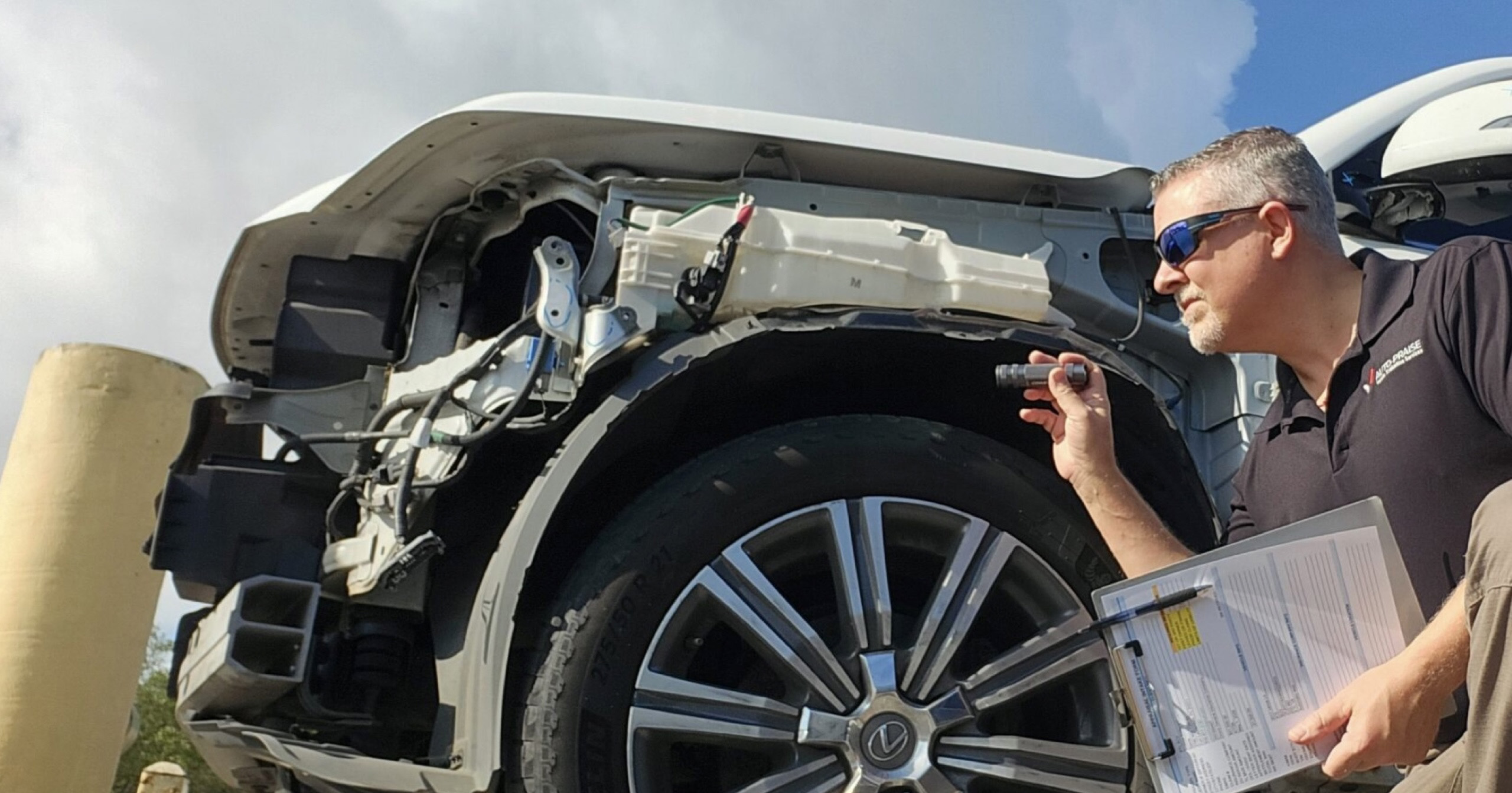 Auto Praise appraiser evaluating a Lexus during a vehicle appraisal in Fort Lauderdale Florida
